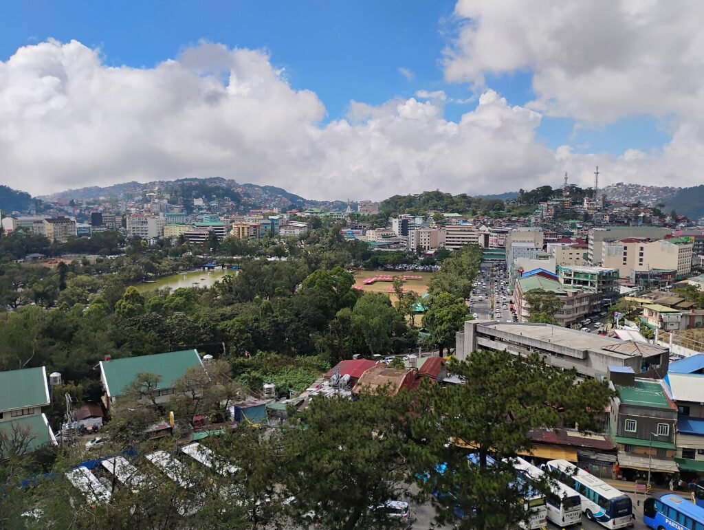 The Baguio skyline from above: houses stepping down the slopes among pine trees
